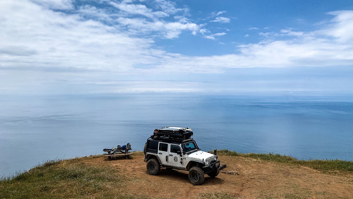 Sandpiper rooftop tent on jeep with surfboards attached