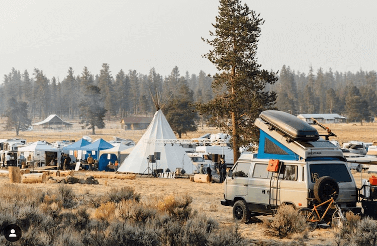 Van lifers and overlander at descend on bend, Van with rooftop camper at festival with big tent and stage